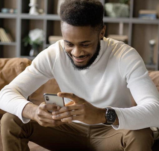 a man texting while sitting down